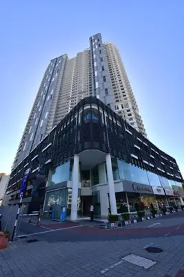 a large tall building with a lot of windows at Black Martini Premium Suite in Tanjong Tokong