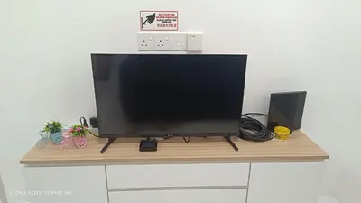 a television sitting on top of a wooden shelf at ZIE HOMESTAY AT SOHO Seri Iskandar in Seri Iskandar