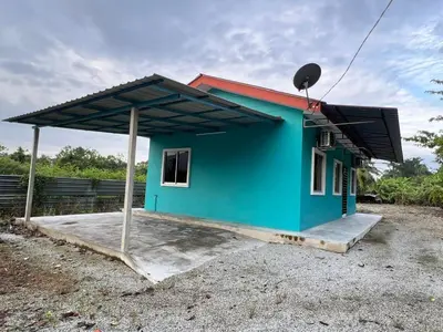 a small blue house with a red roof at Leman's Homestay in Balik Pulau