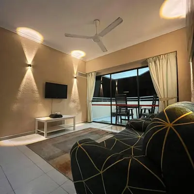 a living room with a couch and a television at Batu Ferringhi Sri Sayang in Batu Ferringhi