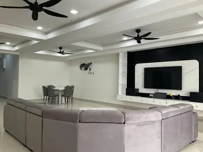 a living room with a large couch and a flat screen tv at Horizon Luxe WiFi n KTV in Sitiawan