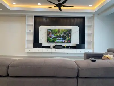 a living room with a couch and a flat screen tv at Horizon Luxe WiFi n KTV in Sitiawan