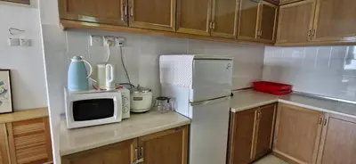 a kitchen with a white refrigerator and a microwave at A23A5 Silverpark HighFloorView in Bukit Fraser