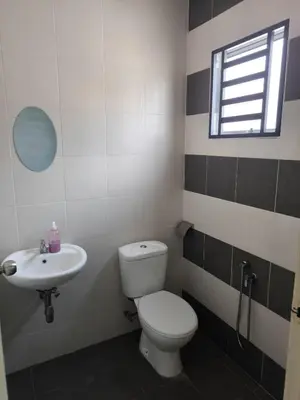 a bathroom with a toilet and a sink at De' Jamboree Homestay in Batu Gajah