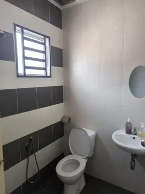 a bathroom with a toilet and a sink at De' Jamboree Homestay in Batu Gajah