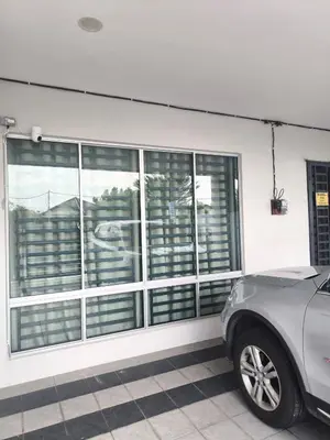 a garage with windows and a car parked in front at De' Jamboree Homestay in Batu Gajah