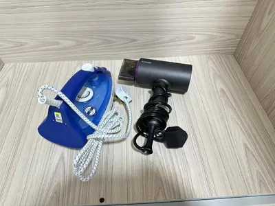 a camera sitting on top of a wooden table at NEW Batu Kawan 2 Bedrooms Suite near IKEA-Columbia Asia Hospital-BKIP-UOW Kdu in Simpang Ampat