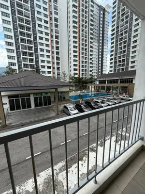 a balcony with cars parked in a parking lot with tall buildings at HSL Homestay Meru in Ipoh