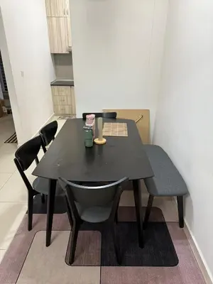 a black table and chairs in a room at HSL Homestay Meru in Ipoh