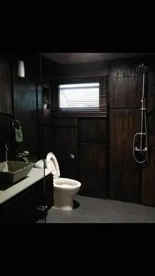 a bathroom with a toilet and a sink at Miracle Suite in Ipoh