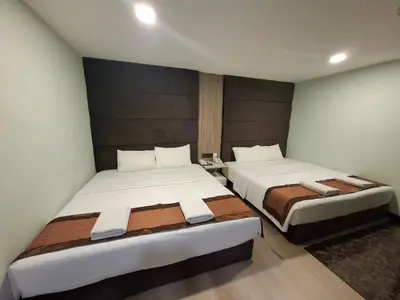 two beds in a hotel room with two bedsvisor at The Corum View Hotel in Bayan Lepas