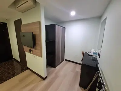 a room with a door and a television on a wall at The Corum View Hotel in Bayan Lepas