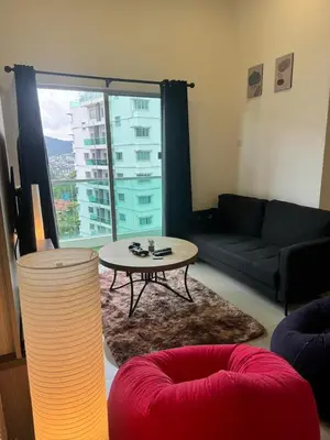 a living room with a couch and a table at Ayaan FIFA Hub Quintet House - Ultimate Gaming Stay in Tanah Rata