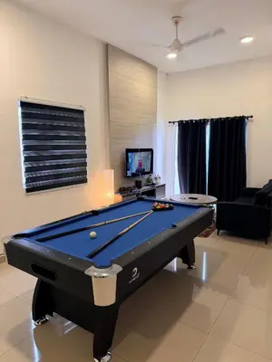 a living room with a pool table in it at Ayaan FIFA Hub Quintet House - Ultimate Gaming Stay in Tanah Rata