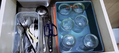 a drawer filled with plastic utensils and spoons at 3-Bedroom Homelike Apartment in Bukit Mertajam in Bukit Mertajam