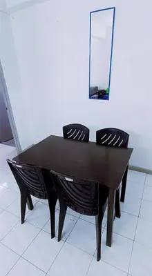 a black table with two chairs and a mirror at 3-Bedroom Homelike Apartment in Bukit Mertajam in Bukit Mertajam