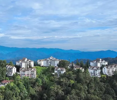 a group of houses on a hill with mountains in the background at B10-5-1 Silverpark Resort -No Lift in Bukit Fraser