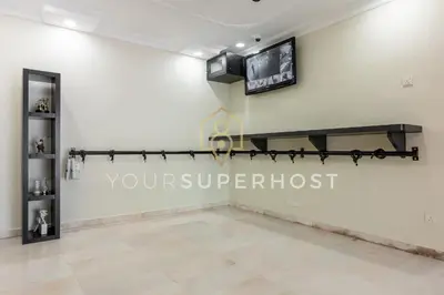 a living room with a tv on the wall at 8 Concordia by YourSuperHost in George Town