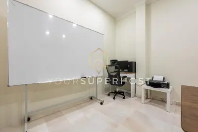 an empty room with a white wall and a white desk at 8 Concordia by YourSuperHost in George Town