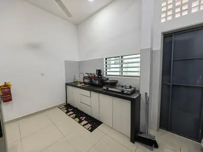 a kitchen with a counter and a large window at Bertam Holiday Homestay 01 in Kepala Batas