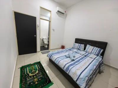 a bedroom with a bed with a teddy bear on it at Bertam Holiday Homestay 01 in Kepala Batas