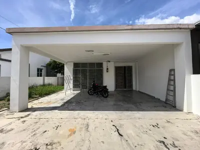 a motorcycle parked in the garage of a house at Padang Serai Wangi Homestay 71 in Padang Serai
