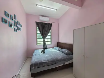 a pink bedroom with a bed and a window at Padang Serai Wangi Homestay 71 in Padang Serai