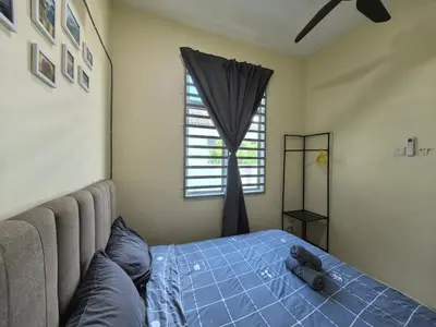 a bedroom with a teddy bear laying on a bed at Padang Serai Wangi Homestay 71 in Padang Serai