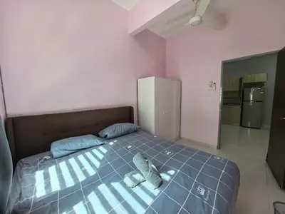 a bedroom with a bed with two stuffed animals on it at Padang Serai Wangi Homestay 71 in Padang Serai