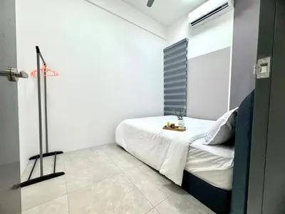 a white bedroom with a bed and a lamp at Aston Acacia Residence Bukit Mertajam in Bukit Mertajam