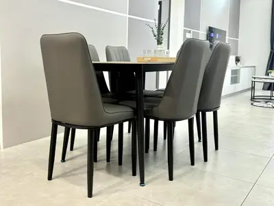 a dining room table with four chairs around it at Aston Acacia Residence Bukit Mertajam in Bukit Mertajam