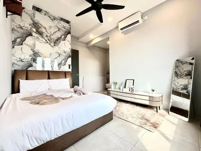 a bedroom with a large bed and a ceiling fan at Aston Acacia Residence Bukit Mertajam in Bukit Mertajam