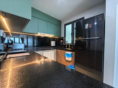 a kitchen with a black refrigerator and a counter top at Meritus Relax Holiday Homestay in Perai