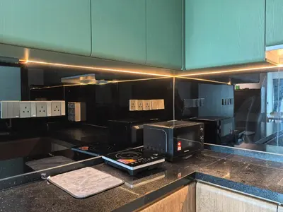 a kitchen with a stove and a microwave on a counter at Meritus Relax Holiday Homestay in Perai
