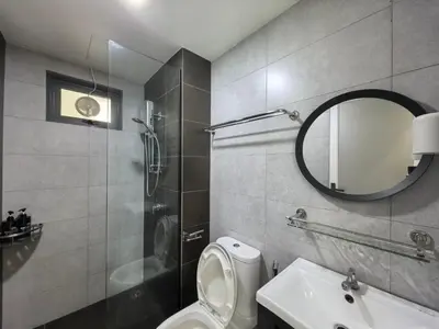 a bathroom with a toilet and a sink and a mirror at Meritus Relax Holiday Homestay in Perai