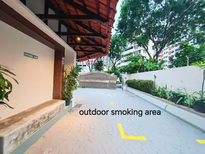 a outside smoking area of a building with a yellow arrow pointing to an outdoor smoking at Mutiara Gurney bySOL at Genesis IVF, Gurney Paragon in George Town