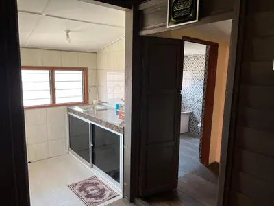 a kitchen with a sink and a counter top at Homestay wak saripan Rumah Kayu in Teluk Intan