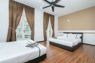 a bedroom with two beds and a ceiling fan at Tanjung Bungah Villa 20 pax Mahjong Snooker and More Close to Beach in Tanjung Bungah