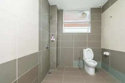 a bathroom with a toilet and a window at Tanjung Bungah Villa 20 pax Mahjong Snooker and More Close to Beach in Tanjung Bungah