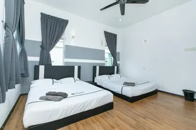 a room with two beds and a ceiling fan at Tanjung Bungah Villa 20 pax Mahjong Snooker and More Close to Beach in Tanjung Bungah