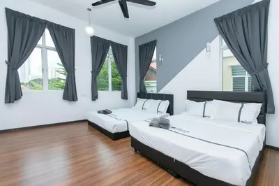 two beds in a room with two windows at Tanjung Bungah Villa 20 pax Mahjong Snooker and More Close to Beach in Tanjung Bungah
