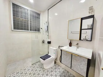 a bathroom with a toilet and a sink and a shower at Ipoh pasir puteh vibrant home 4br 15 pax in Ipoh