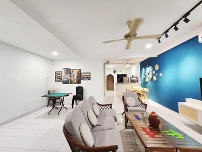 a living room with a couch and a table at Ipoh pasir puteh vibrant home 4br 15 pax in Ipoh