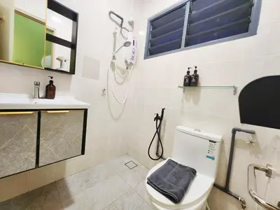 a bathroom with a toilet and a shower and a sink at Ipoh pasir puteh vibrant home 4br 15 pax in Ipoh