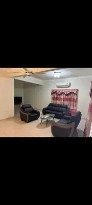 a living room with couches and chairs in a room at Satis Homestay in Taiping