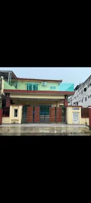 a building with a fence in front of it at Satis Homestay in Taiping