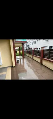 an empty hallway of a building with tables and benches at Satis Homestay in Taiping