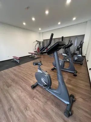 a gym with several exercise bikes in a room at Palas Horizon By Lume' Living Homestay near Kea Farm Market, 2Bedroom, Sunrise View in Brinchang