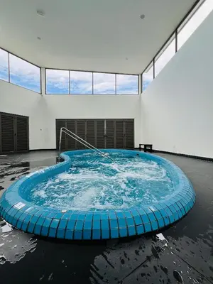a large hot tub in a room with windows at Palas Horizon By Lume' Living Homestay near Kea Farm Market, 2Bedroom, Sunrise View in Brinchang
