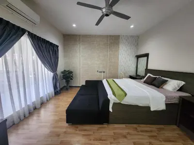 a bedroom with a bed and a ceiling fan at Ipoh Tambun pool villa 5br20pax bbq karaoke mahjong in Ipoh